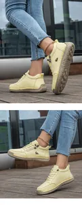 Detalle de zapatos de cuero amarillo con cremallera, costuras a mano y suela de goma