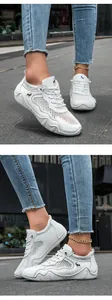 Detail of white mesh sneakers with breathable fabric and anti-slip rubber soles