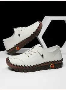 Detailed view of white lychee leather texture and handmade stitching on women flats