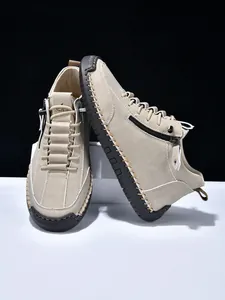 Detail of men's beige suede boots with side zipper and hand-stitched rubber soles