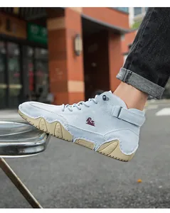 Side view of light blue suede high-top boots featuring red logo and rubber soles