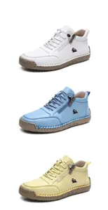 Vertical stack of leather high-top sneakers with side zippers and rubber soles in three colors