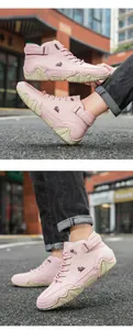 Detail of pink high-top casual outdoor boots with leather texture and non-slip rubber soles