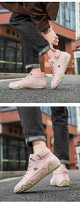 Detailed close-up of pink high-top boots with decorative ankle strap and rubber sole