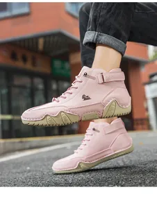 Close-up of pink high-top leather casual boots with non-slip rubber soles and goat logo