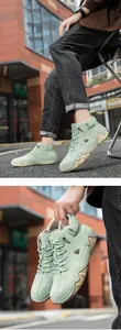 Detail of light green suede high-top boots with textured gum sole and side logo embroidery
