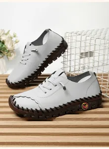 Macro view of grey textured leather casual shoes with hand-stitched details and non-slip sole