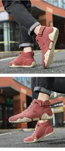 Detail of dark red suede high-top boots featuring wave-pattern rubber soles and velcro straps