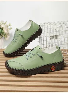 Detail view of green leather casual loafers featuring thick soles and hand-stitched seams