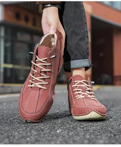 Close-up of brown casual boots with white contrast stitching and durable rubber soles