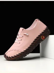 Detail of pink pebbled leather shoe with hand-stitched sole and rubber bottom