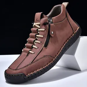 Men's brown leather mid-top boots with decorative hand-stitching and rubber toe cap