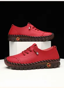Macro shot of red leather loafers showing contrast stitching and anti-slip rubber soles