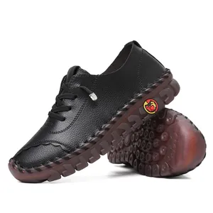 Detail of handmade stitching on black leather loafers with translucent non-slip rubber soles