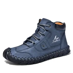 Detailed close-up of blue suede boots featuring vintage hand-stitched welt and side logo