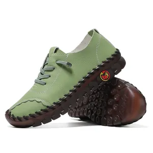 Detail of pea green leather texture and durable thick rubber sole with contrast stitching