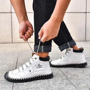 Detail shot of men's white leather combat boots featuring distinctive hand-stitched soles