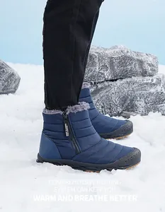 Detail of waterproof quilted snow boot with side zipper and warm fur lining in the snow