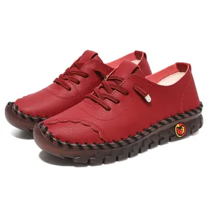Close-up of dark red leather shoes with handmade stitching and thick rubber soles