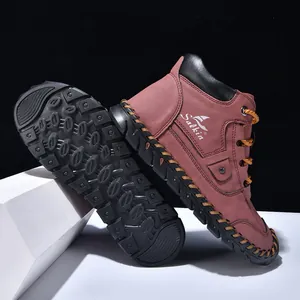 Detail of burgundy leather boots showing non-slip rubber soles and handmade stitching