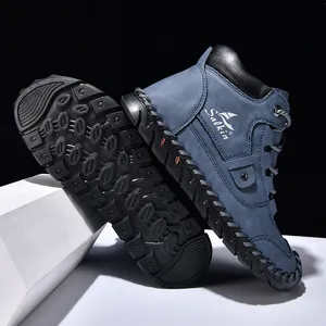 Detailed view of deep blue nubuck leather outdoor boots with thick non-slip rubber soles