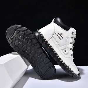 Detail of white leather men's ankle boots featuring hand-stitched seams and logo