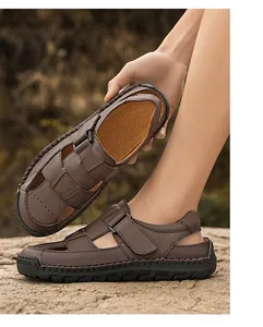 Detail of dark brown leather sandals showing hand-stitched seams and adjustable strap