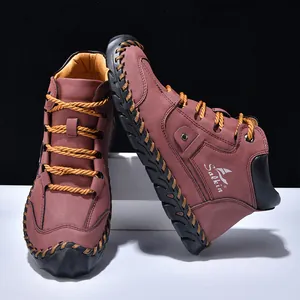 Detail of handmade stitching on men's color-block leather boots with thick rubber soles