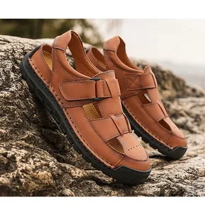 Detail of premium brown leather men's sandals featuring rugged stitching and rubber soles