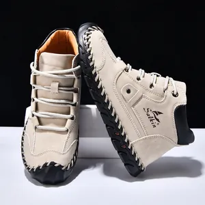 Detail of handcrafted stitching and durable rubber sole on men's khaki suede boots
