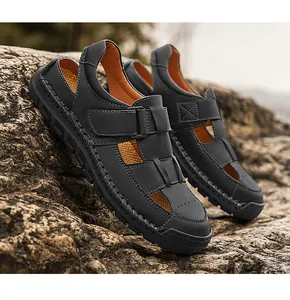 Detail of men's leather sandals on rock showing 100% rubber anti-slip sole texture