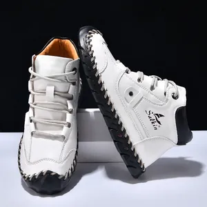 Detail of hand-stitched leather upper and Salkin brand logo on white high-top boots
