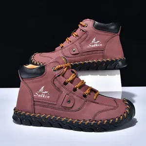 Detail of burgundy leather work boots with Salkin logo and yellow stitching on black sole