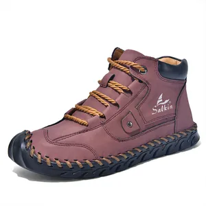 Detailed close-up of brown leather ankle boots with hand-stitched seams and laces