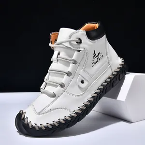 Men's high-top white leather boots with thick black rubber soles and contrast hand-stitching