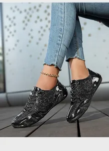 Detail von schwarzen Pailletten-Freizeitschuhen für Damen mit Glanzfinish und Goldkette