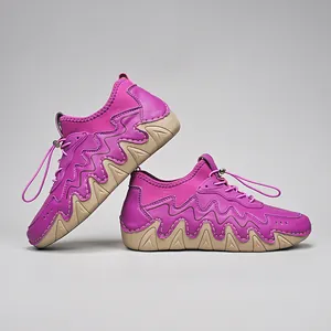 Detail view of purple outdoor sneakers featuring wave-shaped rubber soles and drawstring