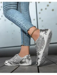Detailansicht der silbernen Pailletten-Sneaker mit Spiegeleffekt und weißer flacher Sohle