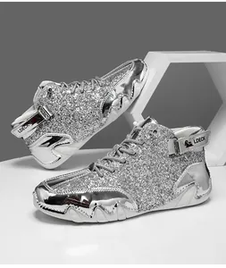 Dettaglio macro di paillettes argento e pelle metallizzata su stivali alti