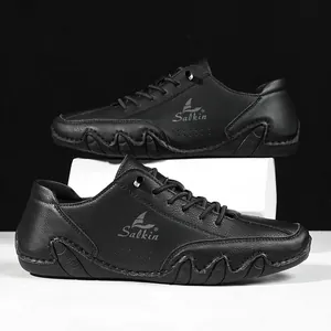 Detail of men's black leather casual shoes featuring textured grain and white rubber sole