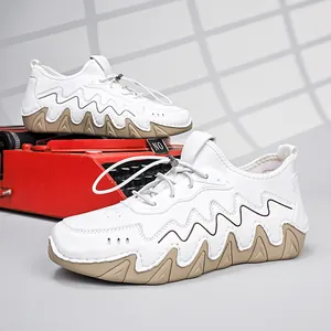 Detail of white casual shoes with wavy rubber soles and toggle lacing system