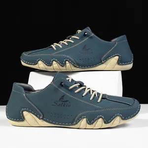 Detail of dark blue nubuck leather boots for men with textured rubber outsole