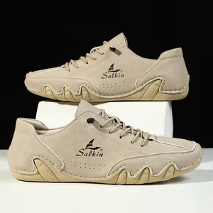 Close-up of beige suede casual loafers with Salkin logo and wavy rubber sole detail