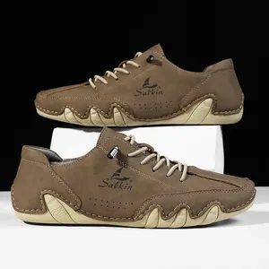 Detail of brown leather casual shoe with side ventilation holes and white rubber sole