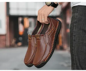 Detail of brown leather loafers featuring handcrafted stitching and lychee grain texture