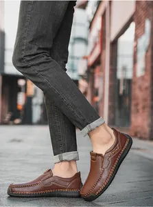Close-up of brown leather casual loafers with textured hand-stitching and rubber sole
