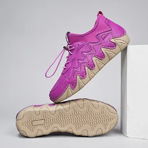 Detail of purple outdoor sneakers with wavy traction sole and drawstring lace system