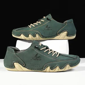 Detail of dark green nubuck leather men shoes with wave textured rubber sole