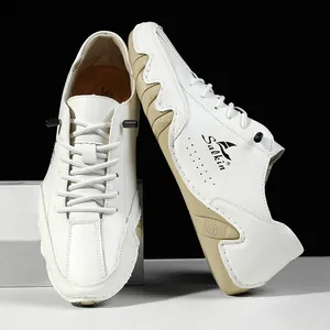 Detailed close-up of white leather casual sneaker with textured beige rubber sole