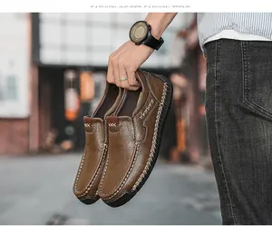 Detail view of brown leather loafers with white stitching and non-slip rubber soles